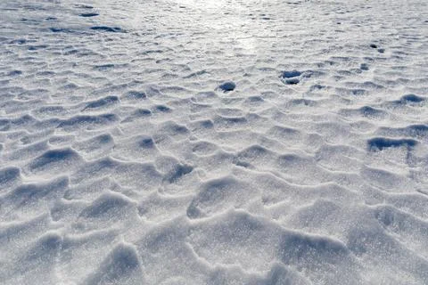 Textured background of a wind-rippled snow surface. Stock Photos