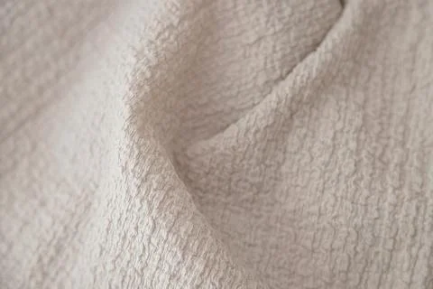 Textured beige fabric background with selective focus Stock Photos