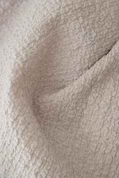 Textured beige fabric background with selective focus Stock Photos