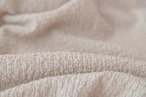 Textured beige fabric background with selective focus Stock Photos