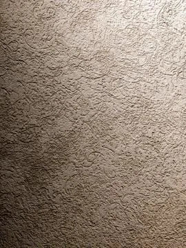 Textured beige plaster wall background with rough surface pattern and shadow Stock Photos