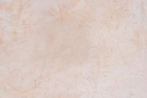 A textured beige plaster wall with subtle scratches and imperfections, crea.. Stock Photos