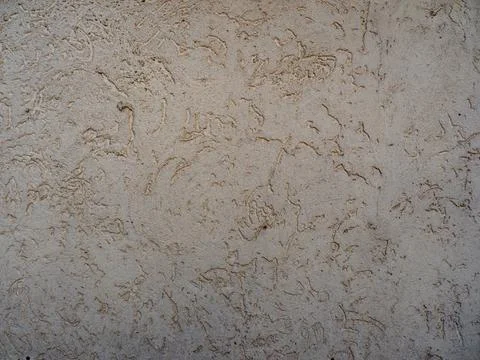 Textured Beige Plaster Wall with Subtle Patterns Stock Photos