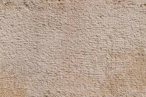 Textured beige stone surface with subtle grid pattern Stock Photos