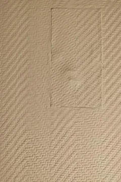 Textured Beige Wall with Rectangular Patch Stock Photos