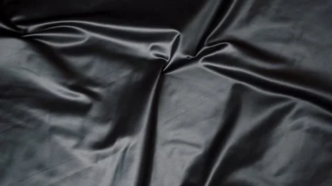 Textured black fabric showcasing waves and folds elegantly Stock Footage 320370006