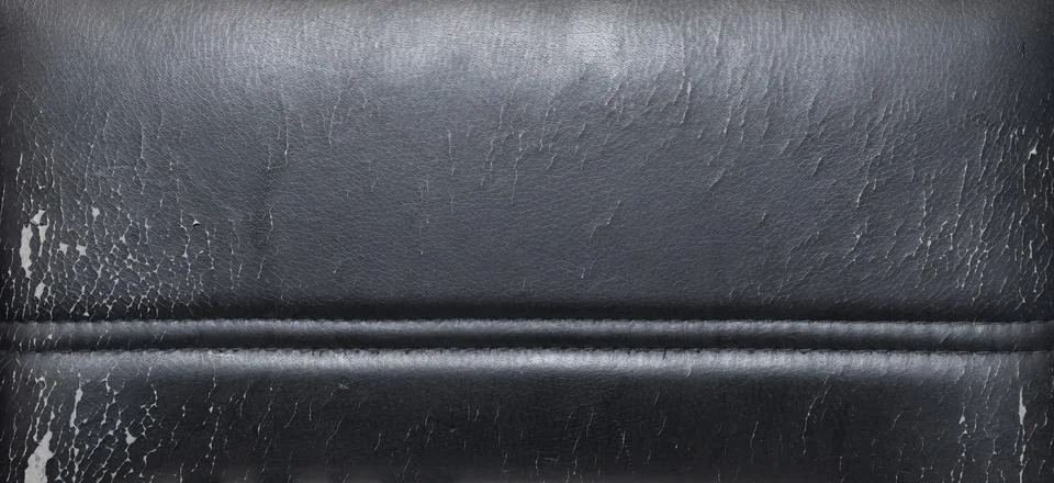 Textured black leather surface with visible wear and tear, showing signs of Stock Photos