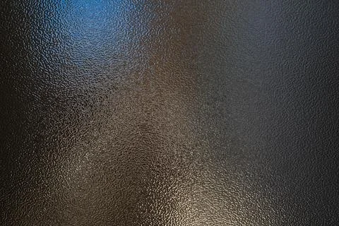 Textured black metallic surface with subtle reflective highlights and uniform Stock Photos