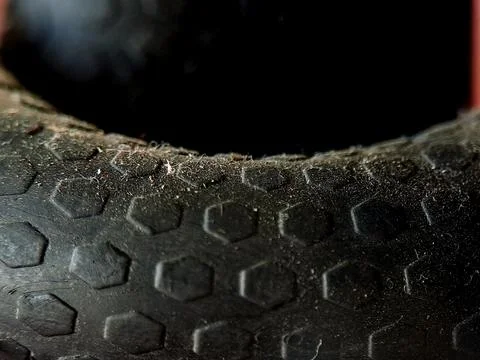 Textured black rubber surface with a repeating pattern and a sense of wear .. Stock Photos