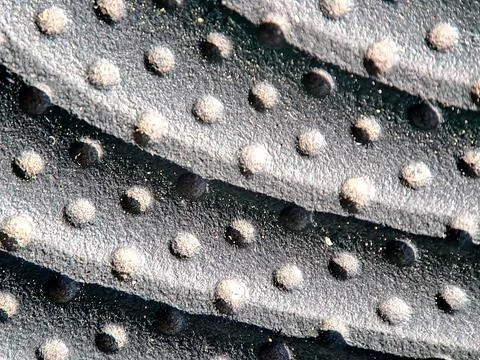 Textured Black Surface with Raised Circular Bumps and Subtle Glittering Par.. 写真素材