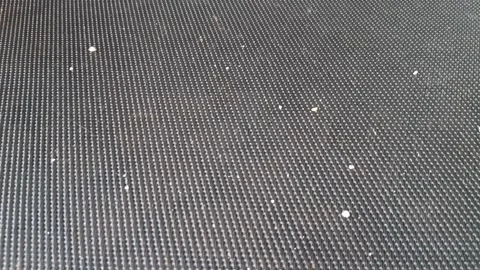Textured black treadmill mat surface moving in a smooth motion video Stock Footage 339507344