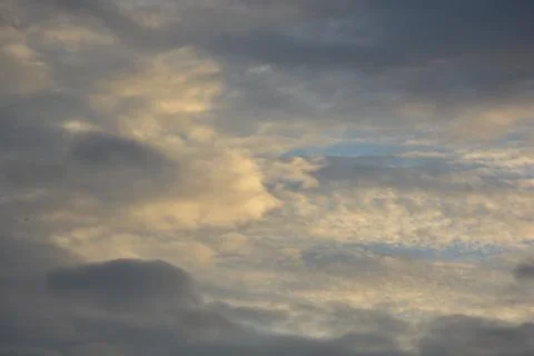 Textured blue sky with warm clouds background and copy space 写真素材