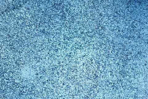 Textured blue surface with speckled pattern, creating calming and serene at.. Stock Photos