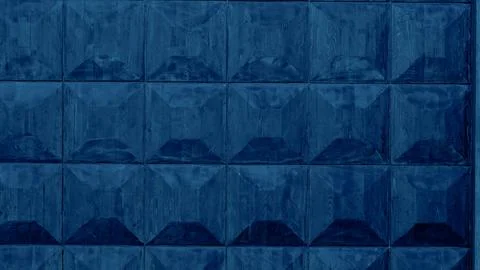Textured blue wall with geometric patterns and glossy finish tiles 스톡 사진