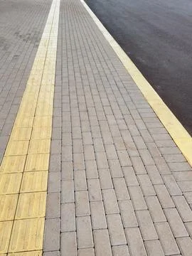 Textured Brick Paver Pathway with Yellow Line – Urban Street Detail Stock Photos