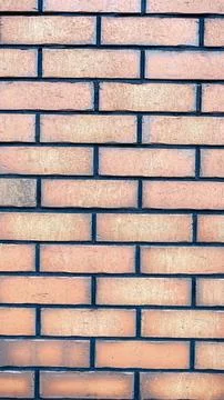 Textured brick wall background with orange clay bricks, dark mortar joints,.. Stock Photos