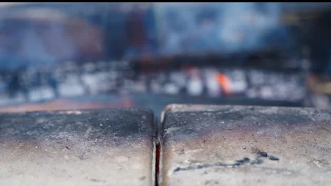 Textured bricks in the foreground and a slow burning fire in the background. The Stock Footage 253171139