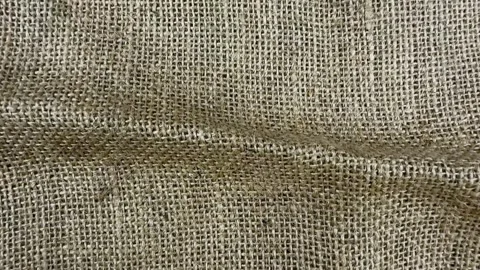 Textured burlap cloth background with woven natural jute fibers, rough brow.. Stock Footage 341915036