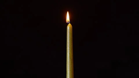 Textured Candle Igniting and Burning in Dark Atmosphere Stock Footage 325545258