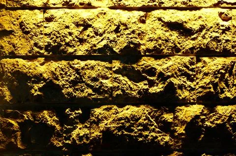 Textured Ceramic Wall Lit with Warm Light Stock Photos