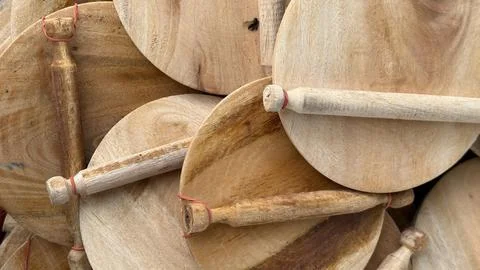 Textured close up of a neat stack of round light wood pizza peels or serving  Stock Photos