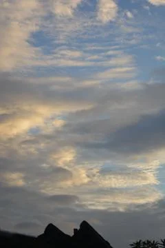 Textured cloud sky background with warm light and blue tones Stock Photos