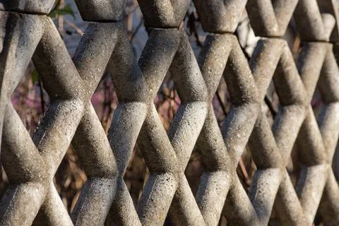 Textured concrete fence with hexagonal patterns creating intriguing visual .. 스톡 사진