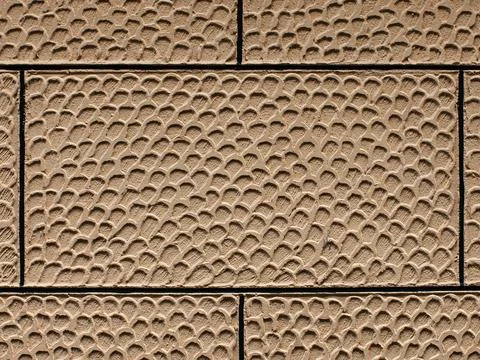 Textured Concrete Tile Facade with Scale Pattern Relief, Beige Architectura.. Stock Photos