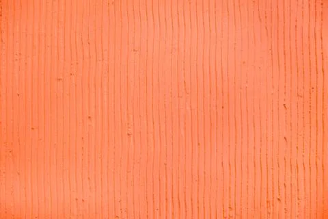 Textured coral background with plaster vertical lines and stripes Stock Photos