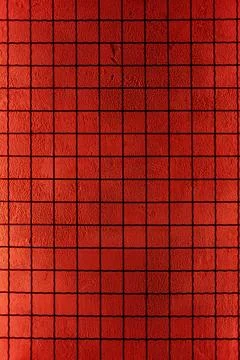 Textured crimson blocks arranged in a precise grid 写真素材