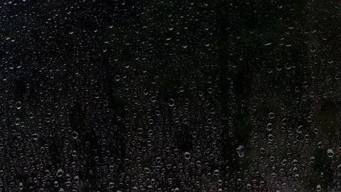 Textured dark background with rain drops falling on a window glass Stock Footage 216683098
