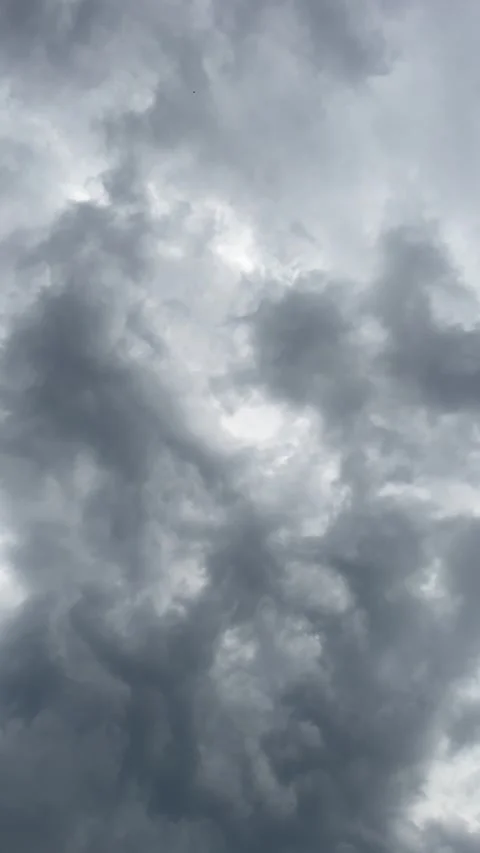 Textured Dark Cloud Formations with Bright Gaps in an Overcast Sky Video stock 201885890