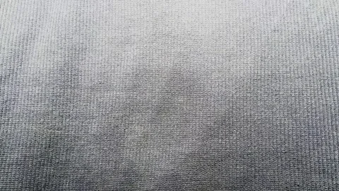 Textured dip dye gray ombre cotton fabric ripples smoothly in a slow panning tra Stock Footage 337550383