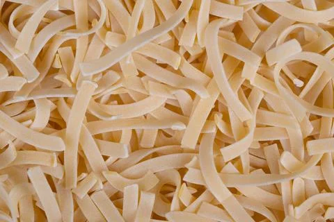 Textured egg noodles background for styling, intricate ribbon patterns, warm  Stock Photos