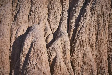 Textured Eroded Rock Formations with Sunlit Shadows and Natural Patterns 写真素材