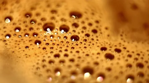 Textured foam bubbles with bokeh effect on the surface of hot cocoa rotate. Stock Footage 205914384