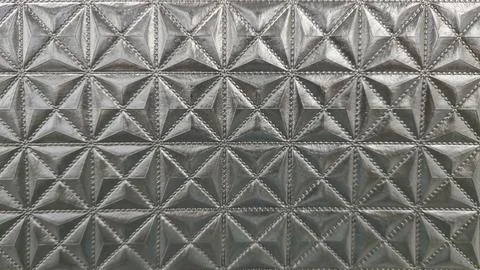  Textured geometric surface with star like patterns, embossed material. Stock Photos