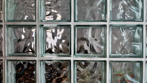 Textured Glass Blocks Create Unique Light Patterns in a Modern Interior Wall Stock Photos