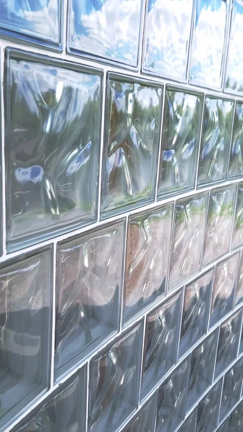 Textured Glass Blocks Wall Reflecting Blue Sky and Clouds Detail Stock Footage 339085920