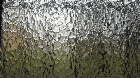Textured glass creating abstract pattern filtering light and obscuring view Stock Photos