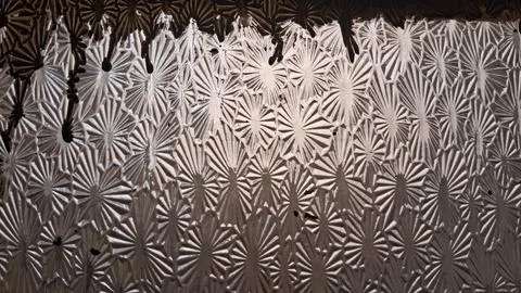 Textured glass surface featuring repeating starburst patterns and vintage light 스톡 사진