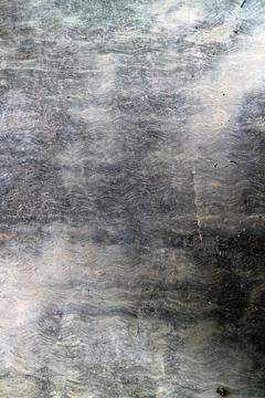 Textured Gray and Black Surface with Swirling Patterns Stock Photos