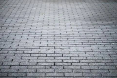 Textured Gray Brick Pavement Background with Patterned Stone Blocks Stock Photos