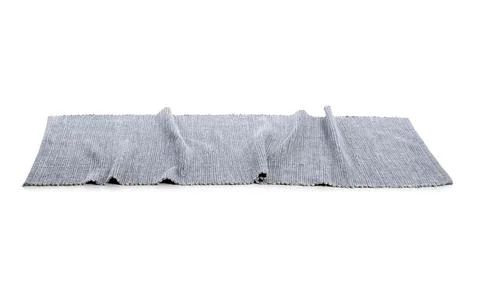 Textured gray fabric table runner with woven pattern and folds, home decor an Stock Photos