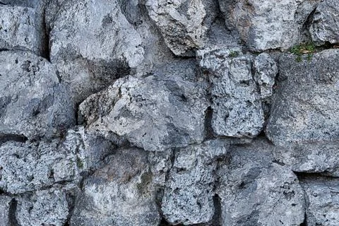 Textured gray stone surface weathered broken blocks uneven stones light base Stock Photos