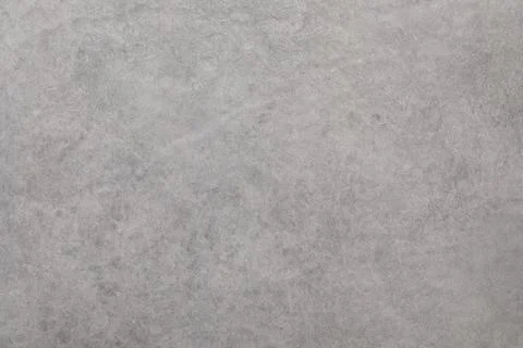 Textured gray surface with subtle patterns and tones ideal for backgrounds in Stockfoto's