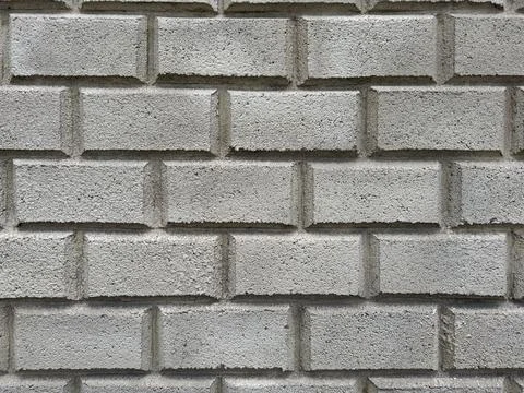Textured grey cinder block brick wall background. Rough cement construction Stock Photos