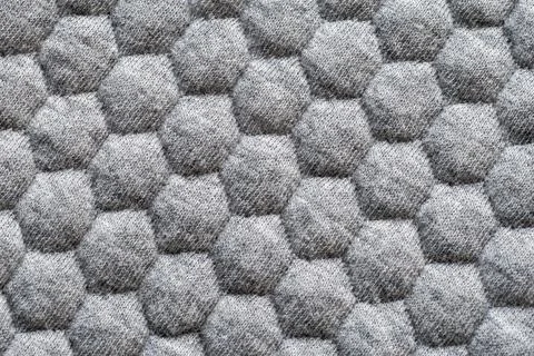 Textured grey fabric with hexagonal mesh pattern Stock Photos