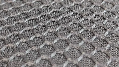 Of a textured grey material, highlighting its rough surface Stock Photos