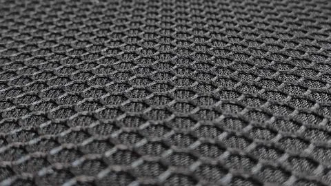 Of a textured grey material, highlighting its rough surface Stock Photos